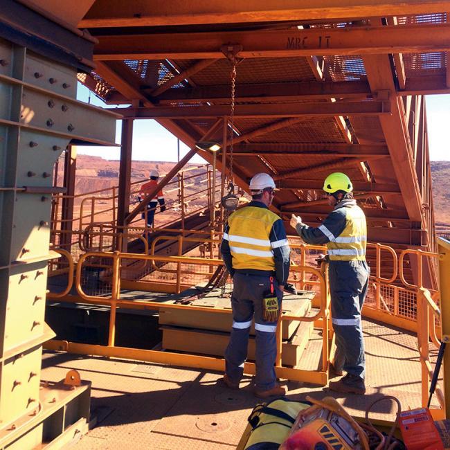 Workers on the elevated MAC TLO working platform during sliding gate integration works