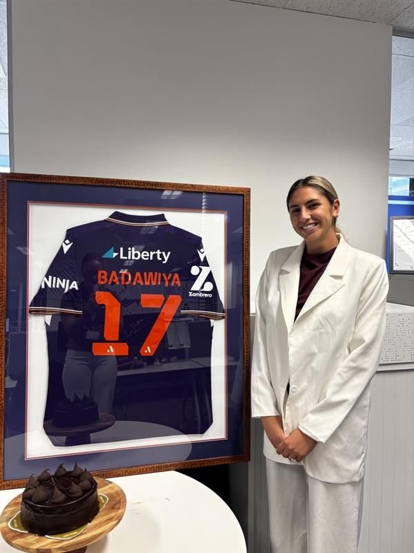 Rola Badawiya with her framed Perth Glory jersey