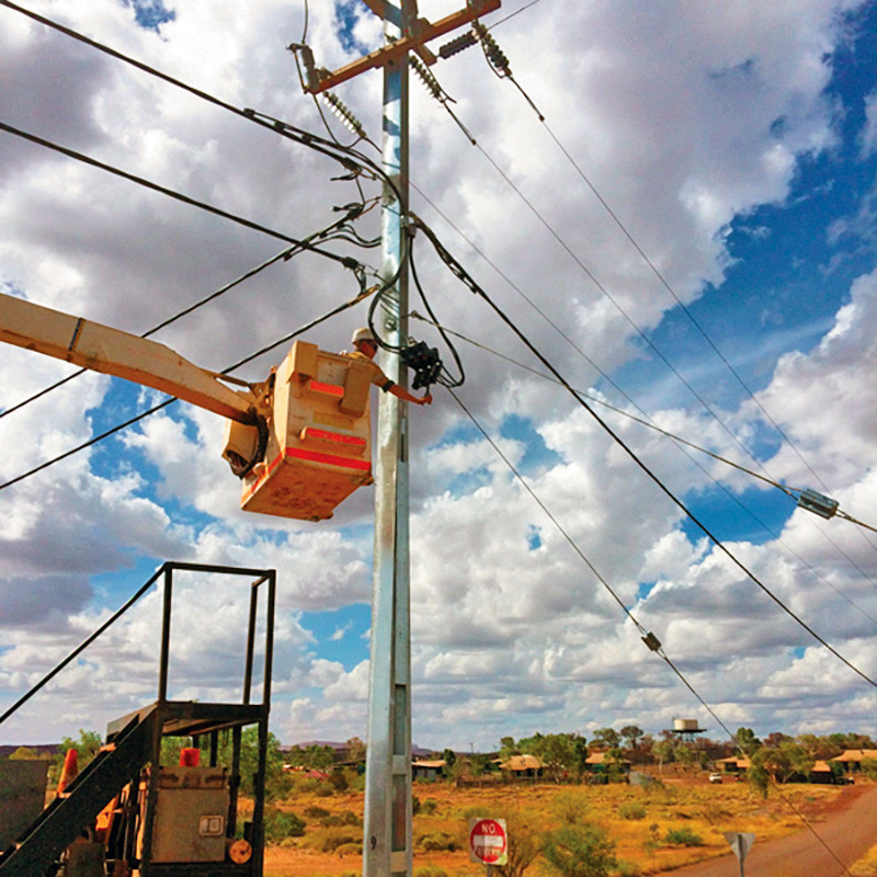 Elevated work platform crew upgrading overhead powerlines in a remote WA community