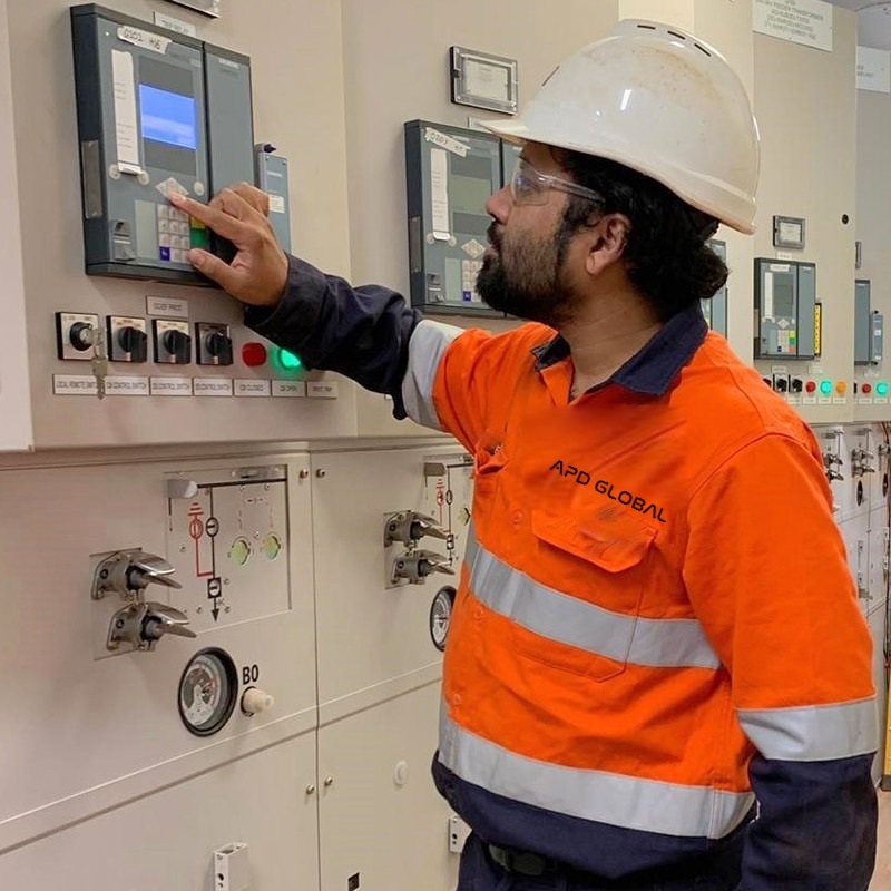 APD technician in hi-vis testing a protection relay on the repurposed 33 kV switchboard