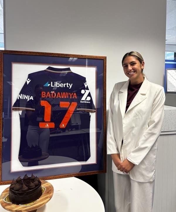 Rola Badawiya with her framed Perth Glory jersey
